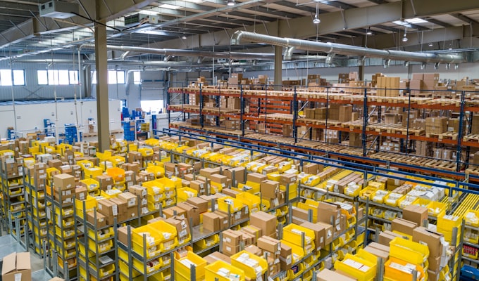 Warehouse with rack of inventory and forklift in motion